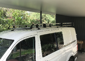 a white van with a roof rack on top