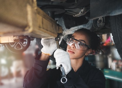an automotive worker working under a car